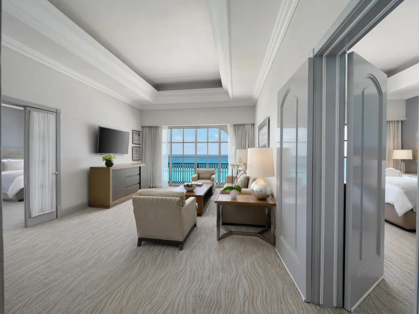 Seaside suite living room with ocean-facing windows at Kempinski Hotel Cancún.
