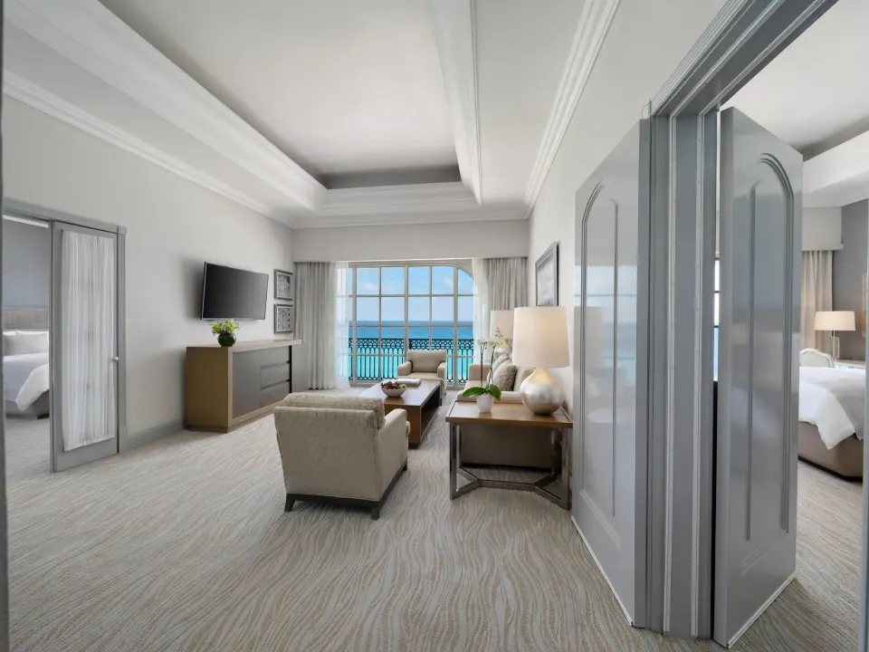 Seaside suite living room with ocean-facing windows at Kempinski Hotel Cancún.