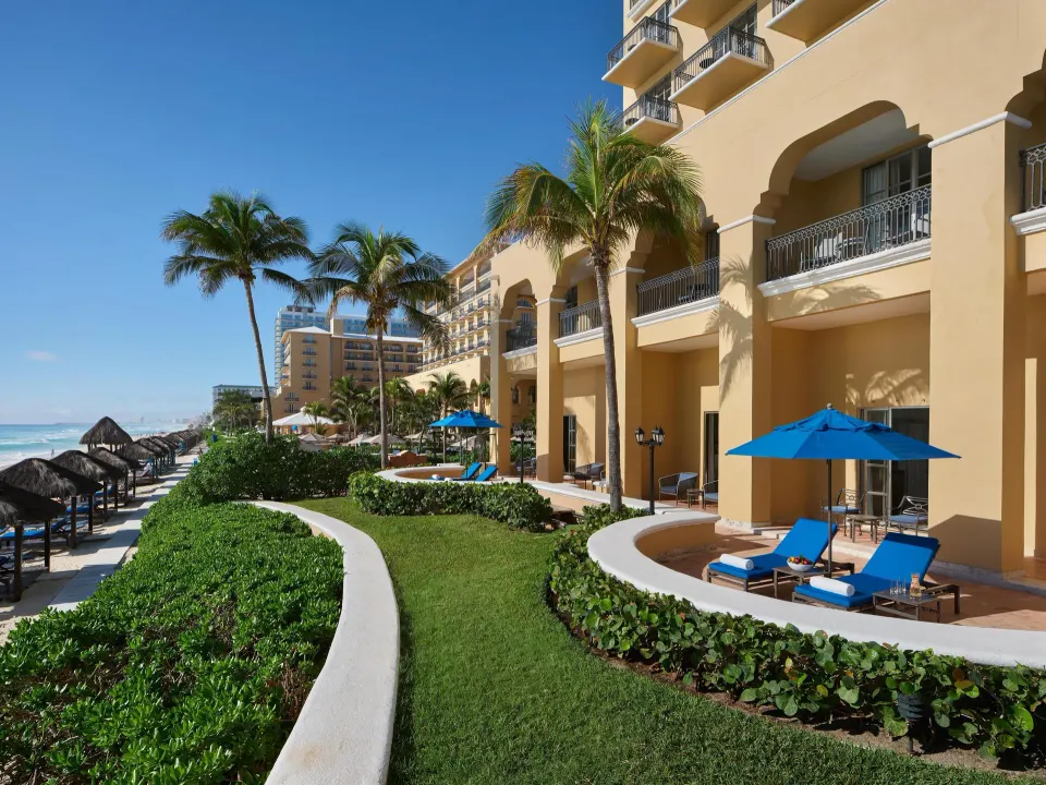 Saasil Suite beachfront patios with blue loungers at Kempinski Hotel Cancún.