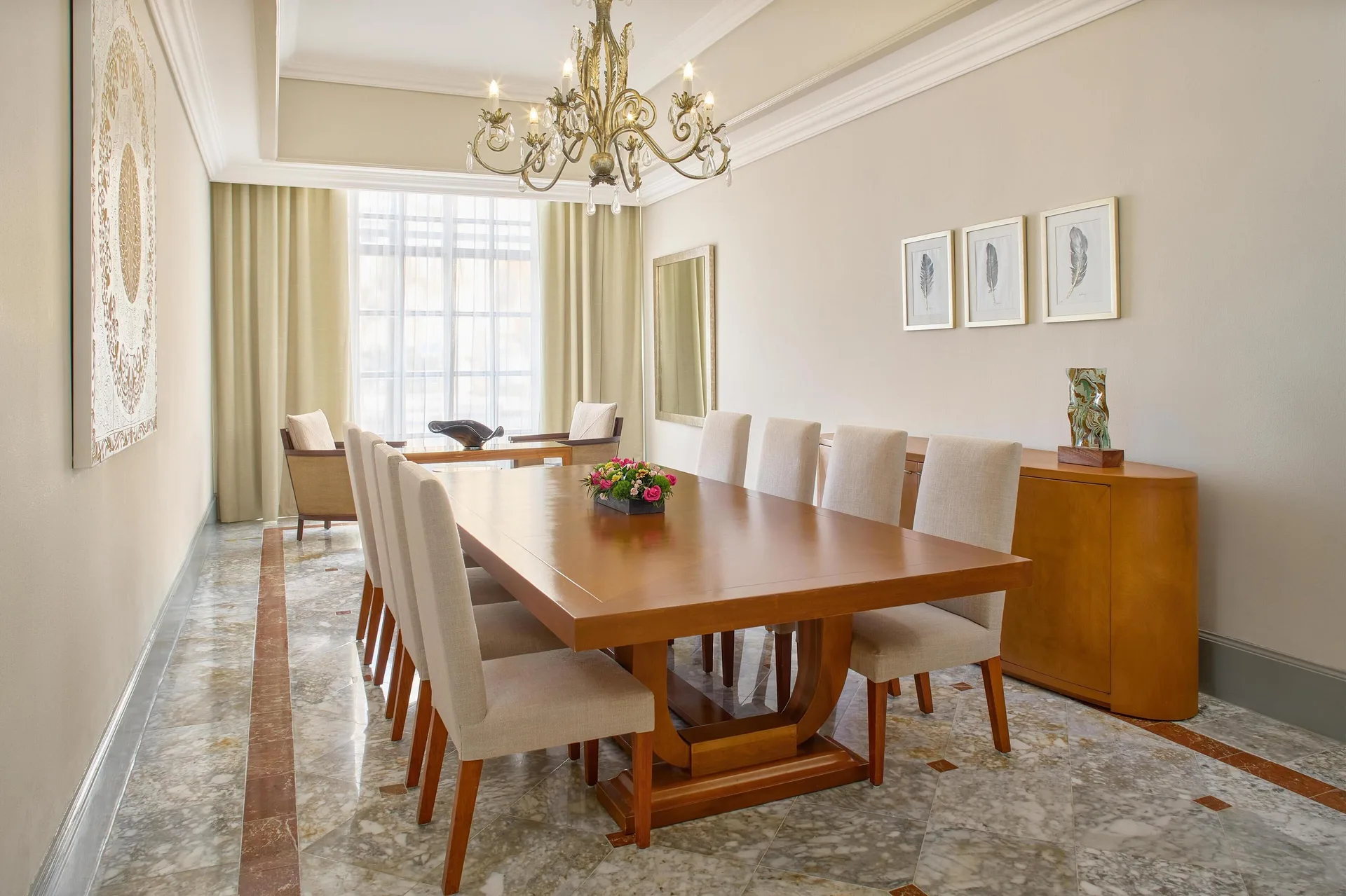 Saasil Suite dining room with long table and chandelier at Kempinski Hotel Cancún.