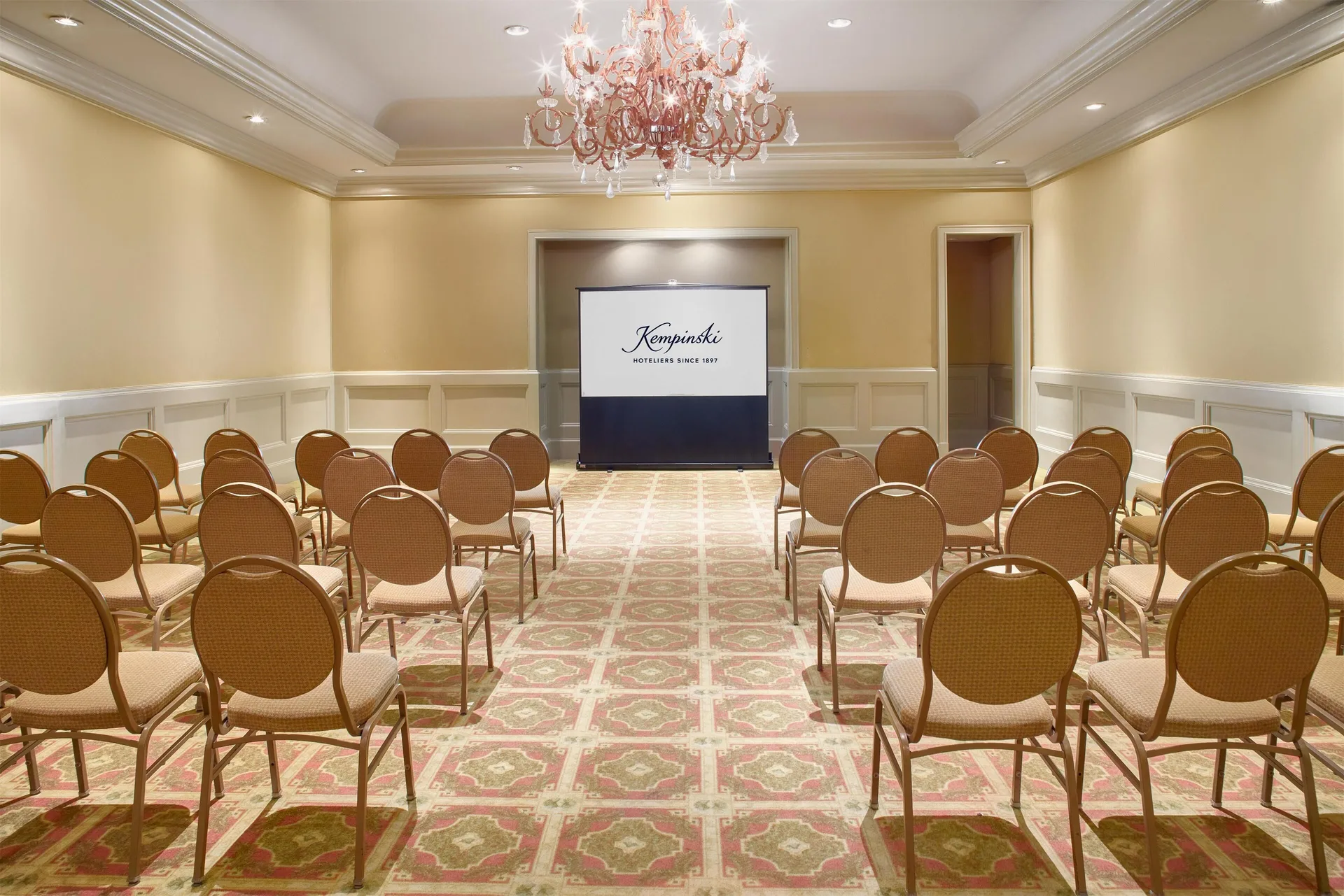 Meeting room with theater seating and presentation screen at Kempinski Hotel Cancún.