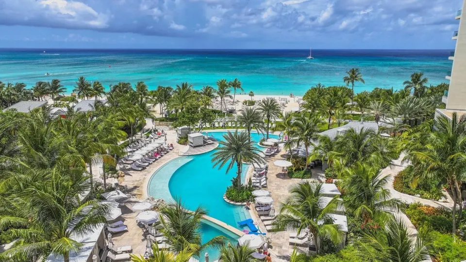 Aerial view of resort pool and turquoise ocean beyond at Kimpton Seafire Resort + Spa