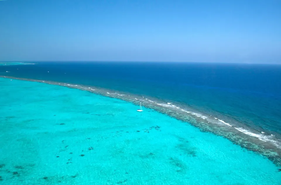 Aerial reef and bright turquoise water off the coast at Kimpton Seafire Resort + Spa