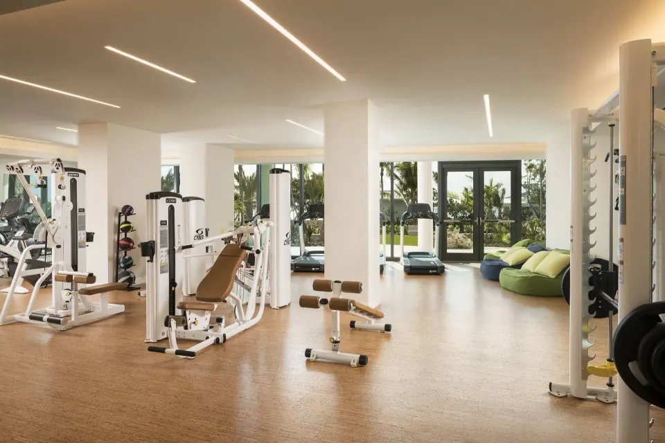 Bright fitness center with weight and cardio equipment at Kimpton Seafire Resort + Spa