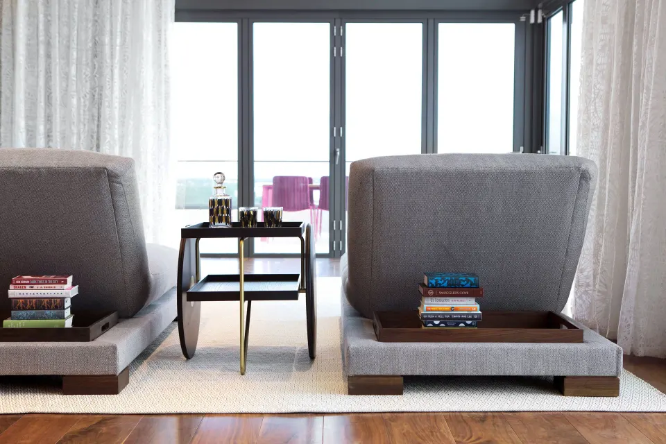 Two lounge chairs facing balcony doors in a guest room at Kimpton Seafire Resort + Spa