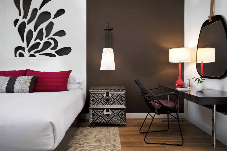 Desk and bedside area in a guest room at Kimpton Seafire Resort + Spa