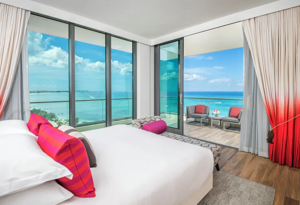 Guest room with king bed and freestanding tub visible behind at Kimpton Seafire Resort + Spa