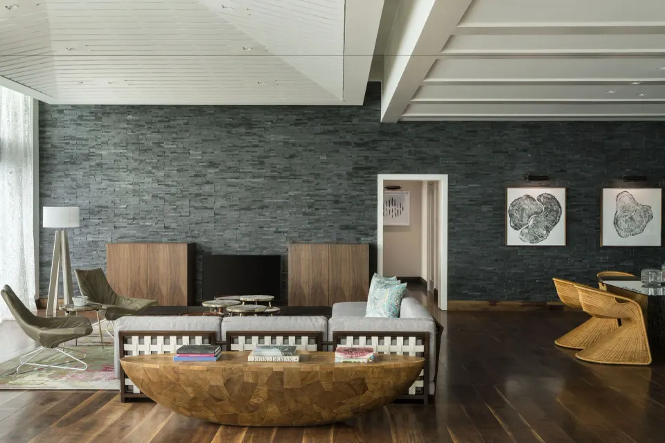 Spacious lobby living area with stone accent wall and wood floors at Kimpton Seafire Resort + Spa