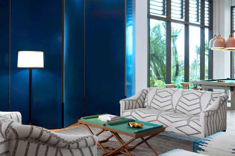 Contemporary lobby seating area with blue accent wall at Kimpton Seafire Resort + Spa