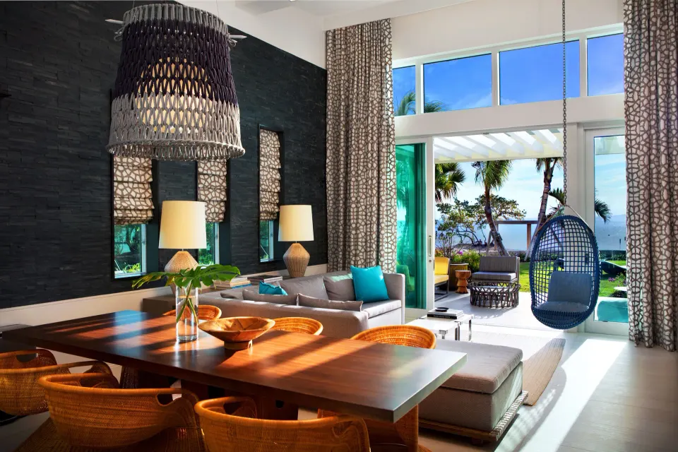 Suite living and dining area opening to a patio and sea at Kimpton Seafire Resort + Spa.