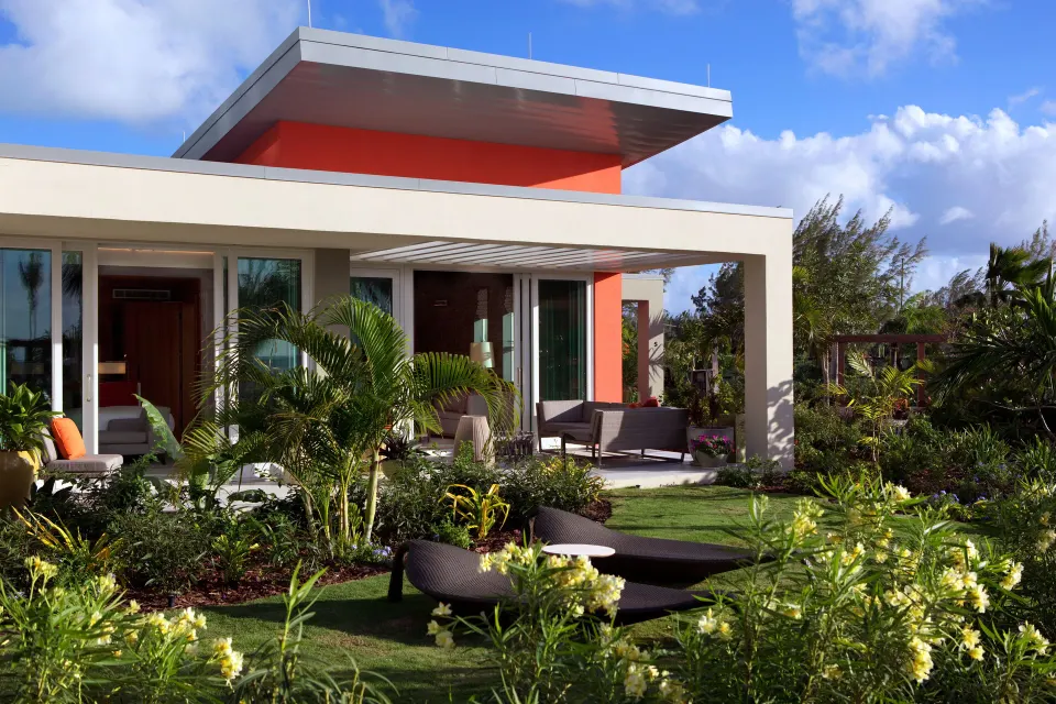 Single-level villa exterior with garden seating at Kimpton Seafire Resort + Spa