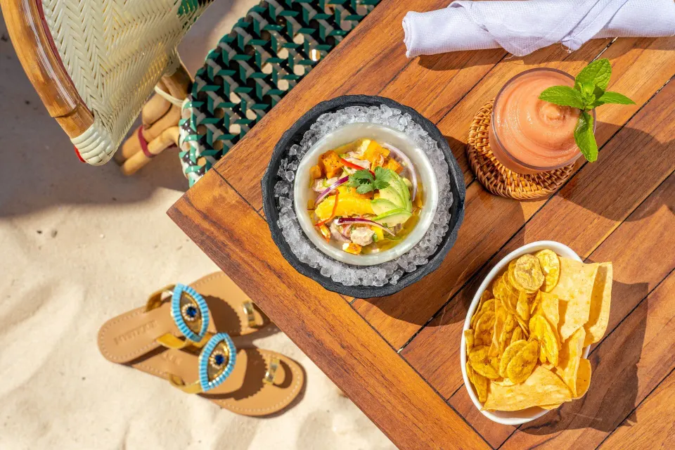 Top-down beach table with ceviche, chips and a smoothie at Kimpton Seafire Resort + Spa.