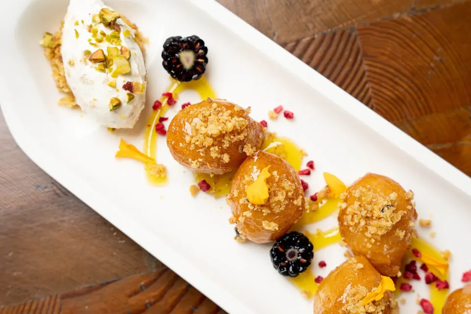 Three caramelized dessert bites with whipped garnish at Kimpton Seafire Resort + Spa