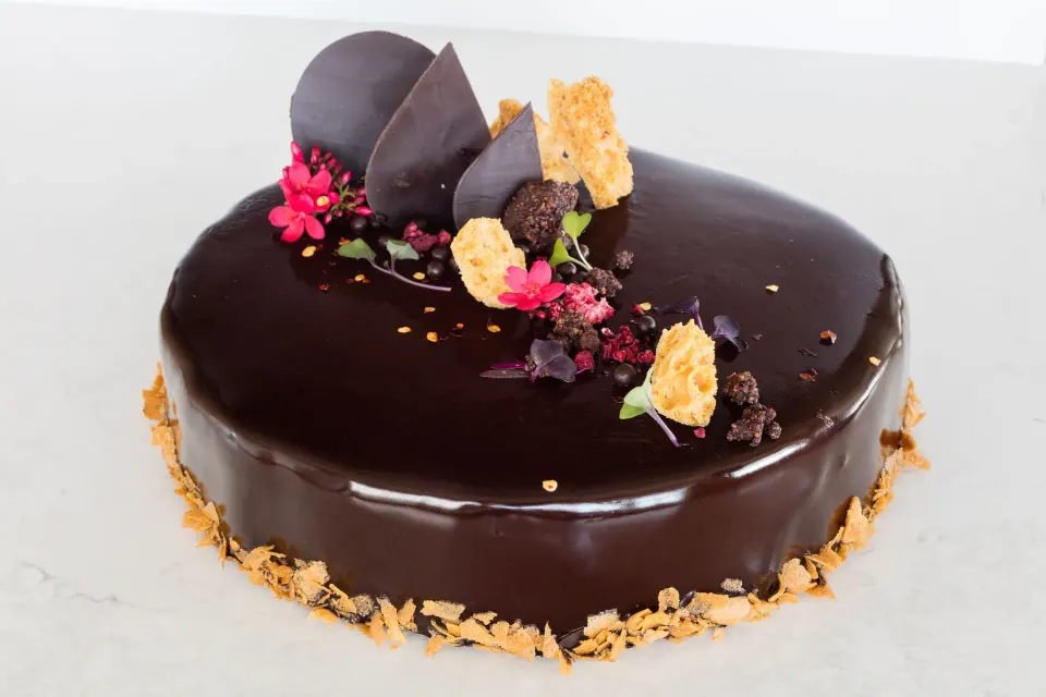 Glazed chocolate mousse torte decorated with petals and crisps at Kimpton Seafire Resort + Spa