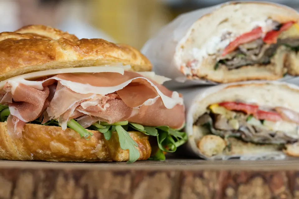 Croissant sandwich with prosciutto and arugula at Kimpton Seafire Resort + Spa
