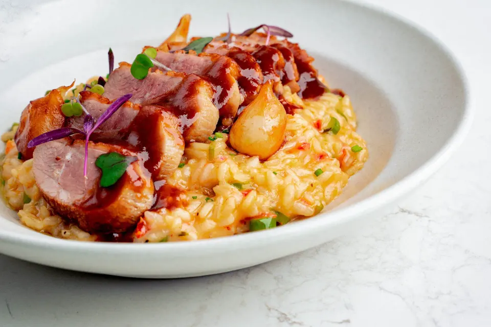 Seared pork over risotto at Kimpton Seafire Resort + Spa