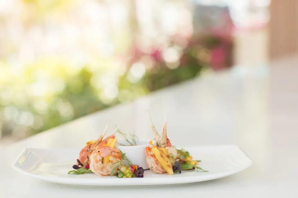 Plated shrimp appetizer on a white plate at Kimpton Seafire Resort + Spa