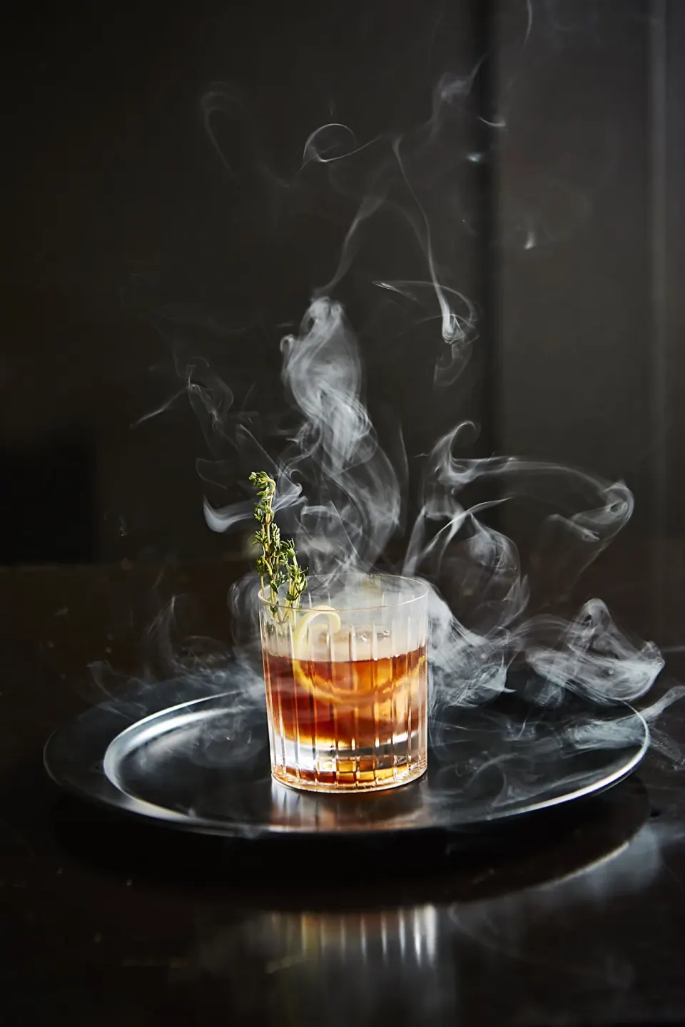 Smoked cocktail on a black tray at Kimpton Seafire Resort + Spa.