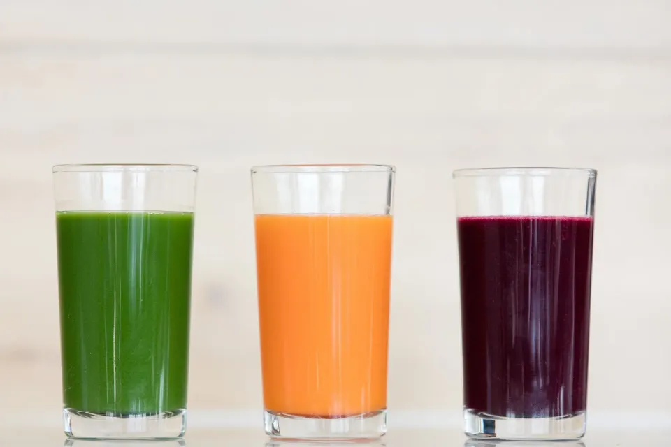 Three colorful fresh juices in clear glasses at Kimpton Seafire Resort + Spa