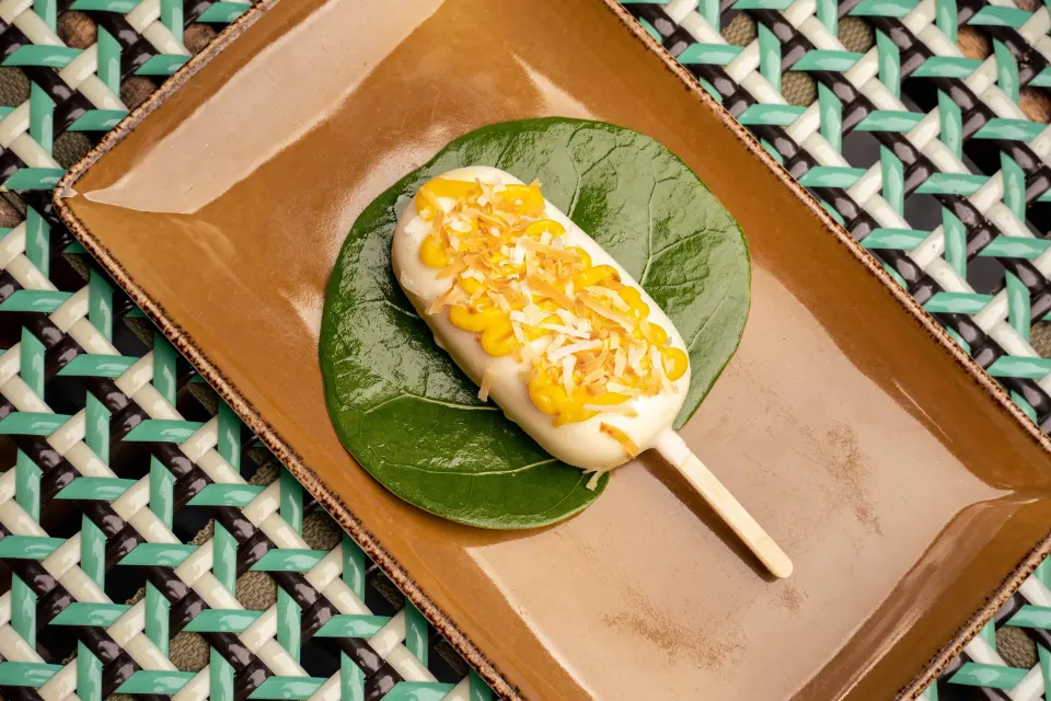 Ice cream or frozen pop topped with sauce on a leaf at Kimpton Seafire Resort + Spa.