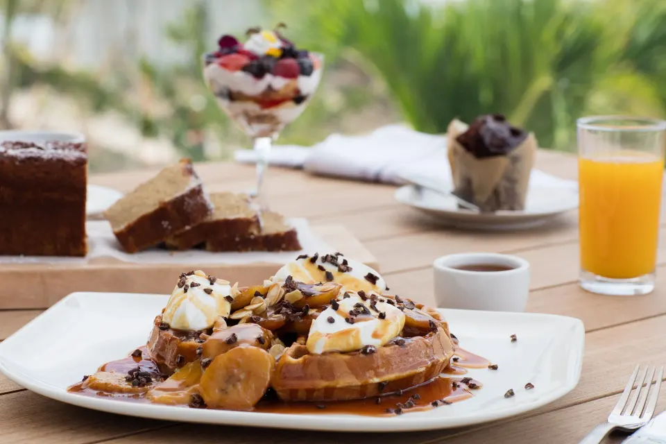 Waffles with caramelized bananas, whipped cream and coffee at Kimpton Seafire Resort + Spa
