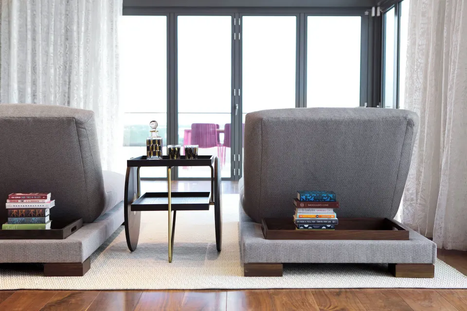 Interior seating with two lounge chairs facing balcony doors in bungalow at Kimpton Seafire Resort + Spa