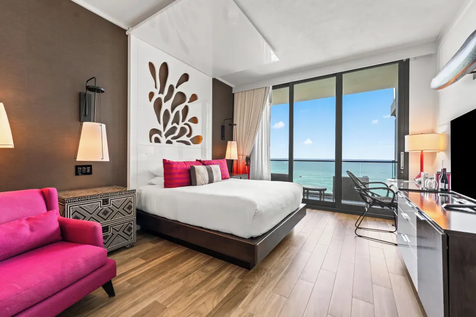 Ocean view king bed and balcony in an Ocean View Room at Kimpton Seafire Resort + Spa