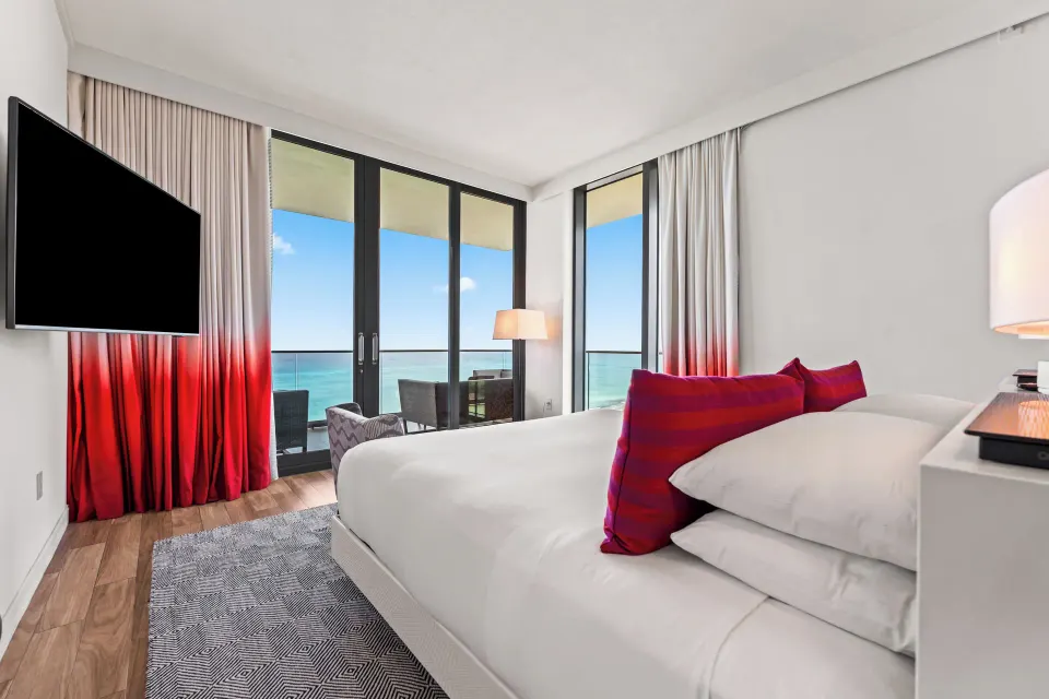 King bed and balcony with ocean view in an Oceanfront One-Bedroom Suite at Kimpton Seafire Resort + Spa