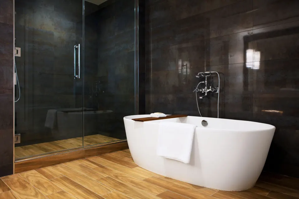 Freestanding tub and glass shower in an Oceanfront One-Bedroom Suite bathroom at Kimpton Seafire Resort + Spa