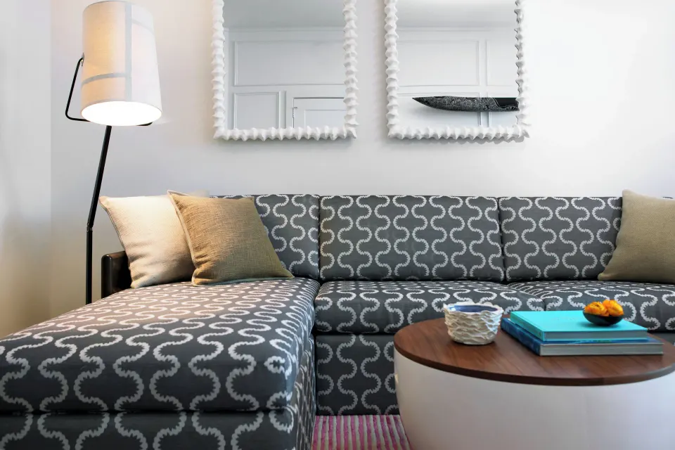 Patterned chaise sofa and coffee table in Oceanfront One-Bedroom Suite at Kimpton Seafire Resort + Spa