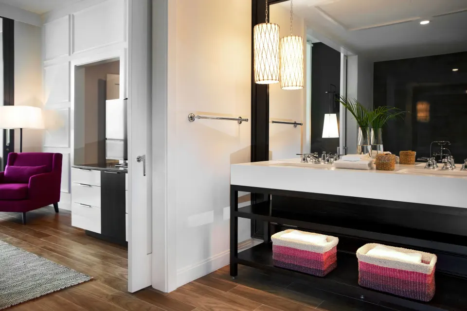 Bathroom vanity and open doorway to bedroom in Oceanfront One-Bedroom Suite at Kimpton Seafire Resort + Spa
