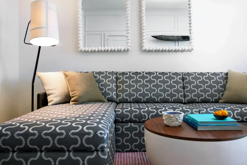 Sectional sofa and lamp in Oceanfront One-Bedroom Suite living area at Kimpton Seafire Resort + Spa