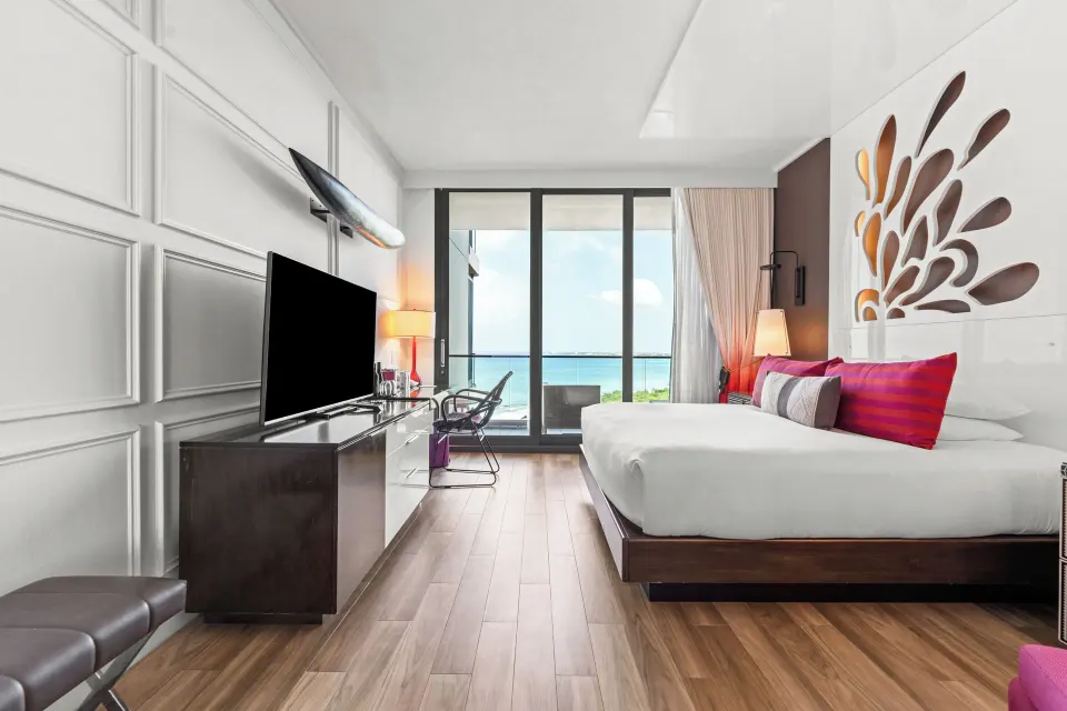 Premium Ocean View King room wide shot with TV console and balcony at Kimpton Seafire Resort + Spa