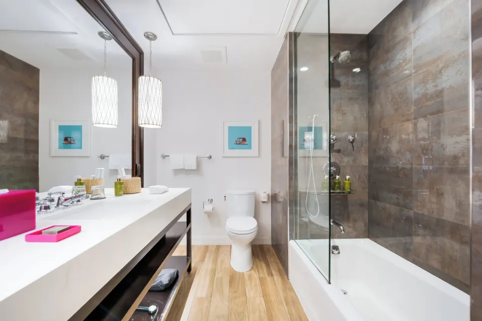 Bathroom with shower-tub and white countertop in a Premium Ocean View One-Bedroom Family Suite at Kimpton Seafire Resort + Sp
