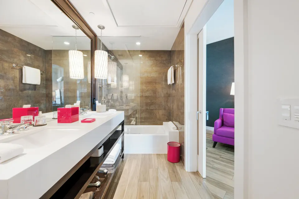 Bathroom vanity and tub with view into the Premium Ocean View Queen Room at Kimpton Seafire Resort + Spa