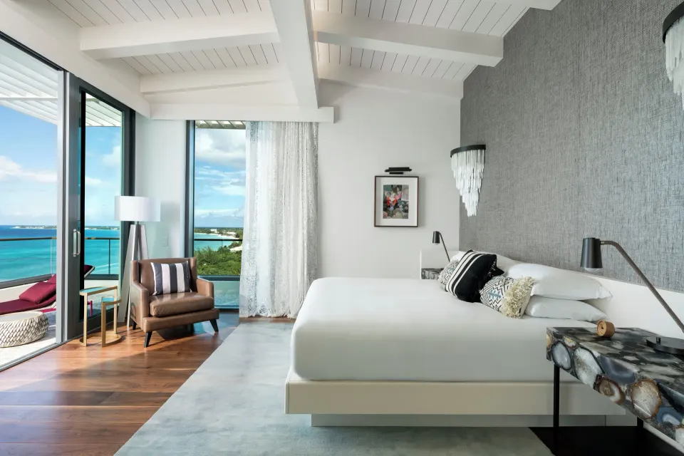 Bright Presidential Oceanfront Two-Bedroom Suite bedroom with king bed and ocean view at Kimpton Seafire Resort + Spa