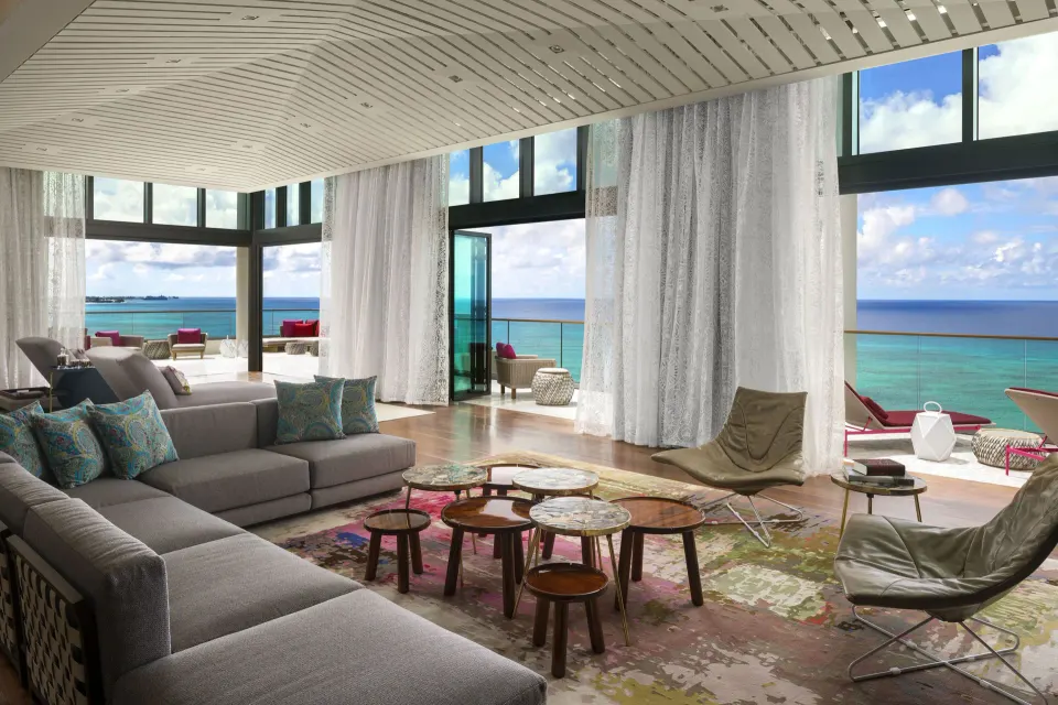 Spacious living area with large windows and ocean view in a Presidential Oceanfront Two‑Bedroom Suite at Kimpton Seafire Reso