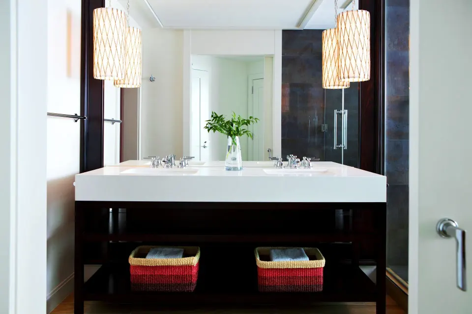 Double sink vanity with pendant lights and storage baskets in Yacht Club View King Room at Kimpton Seafire Resort + Spa