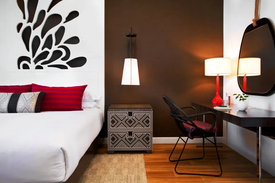Close-up of bedside with pendant light and patterned nightstand in a Yacht Club View King Room at Kimpton Seafire Resort + Sp