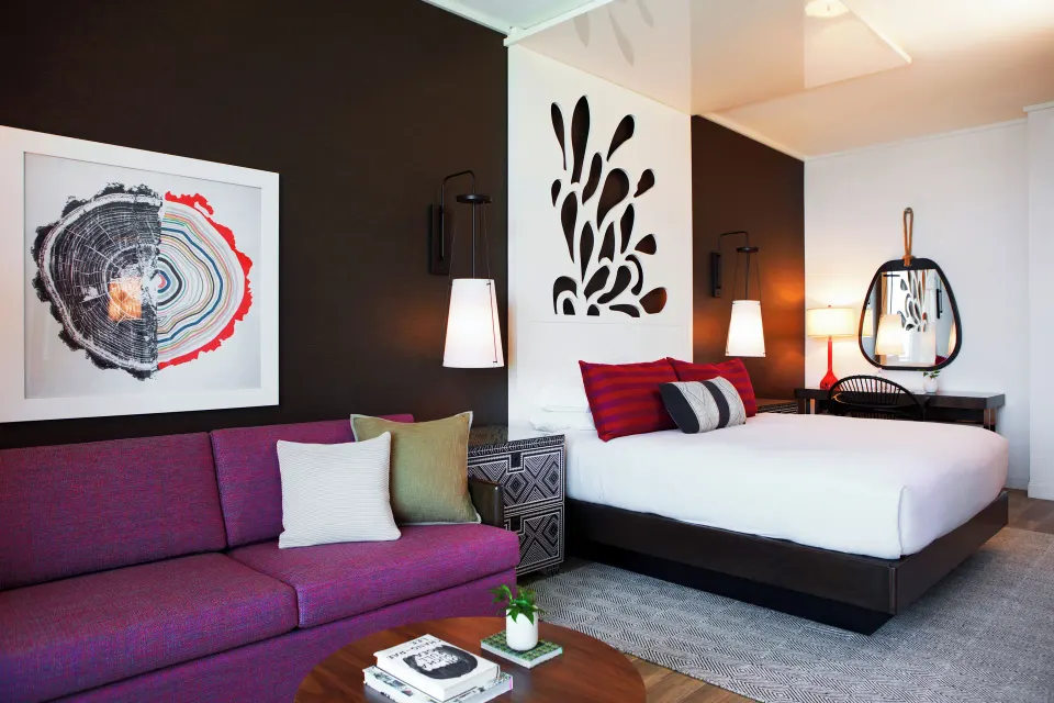 Wide view of king bed and sofa area showing room layout in a Yacht Club View King Room at Kimpton Seafire Resort + Spa
