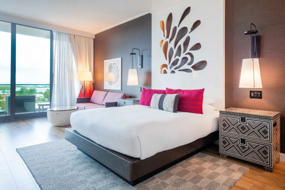 King bed and decorative headboard in Yacht Club View King room at Kimpton Seafire Resort + Spa