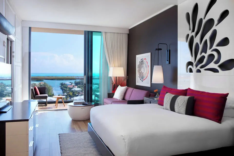 Modern Yacht Club View King room showing bed, sofa and balcony at Kimpton Seafire Resort + Spa