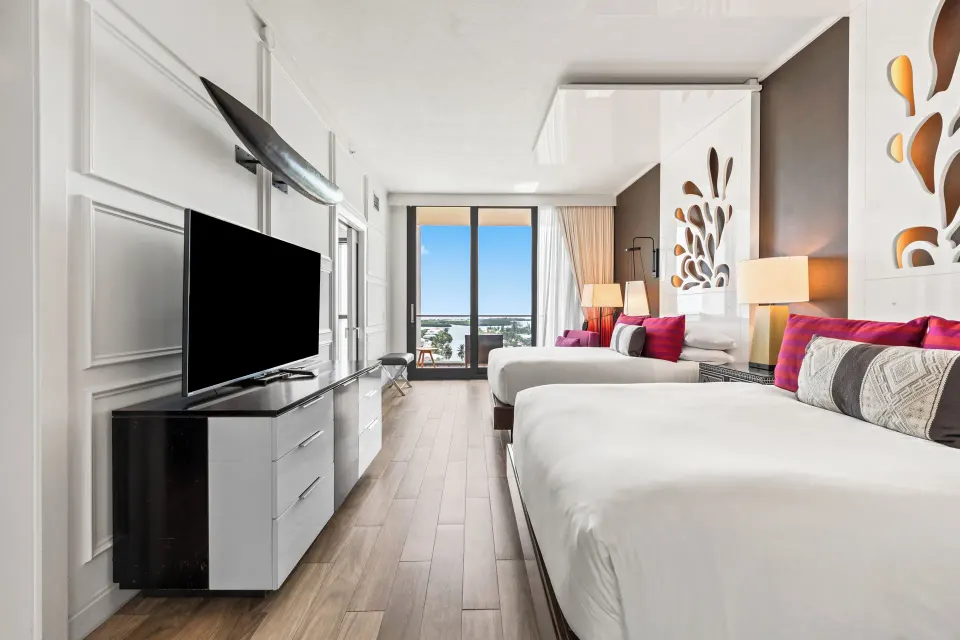 Yacht Club View Queen Room from entry showing TV console and balcony at Kimpton Seafire Resort + Spa
