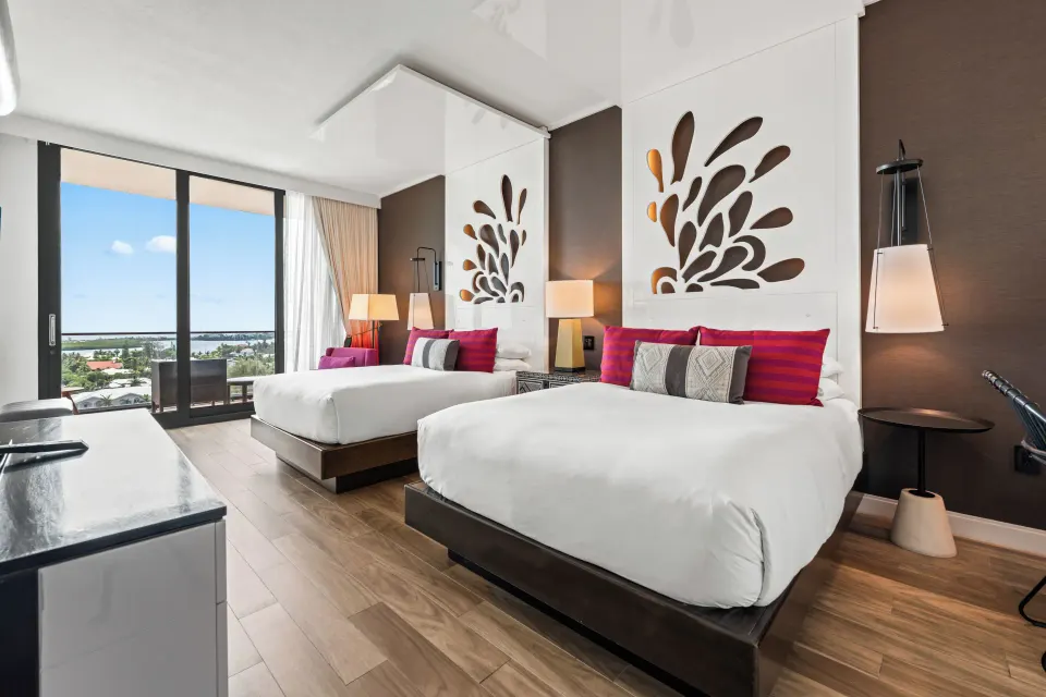 Yacht Club View Queen Room showing beds, hardwood floor and balcony at Kimpton Seafire Resort + Spa