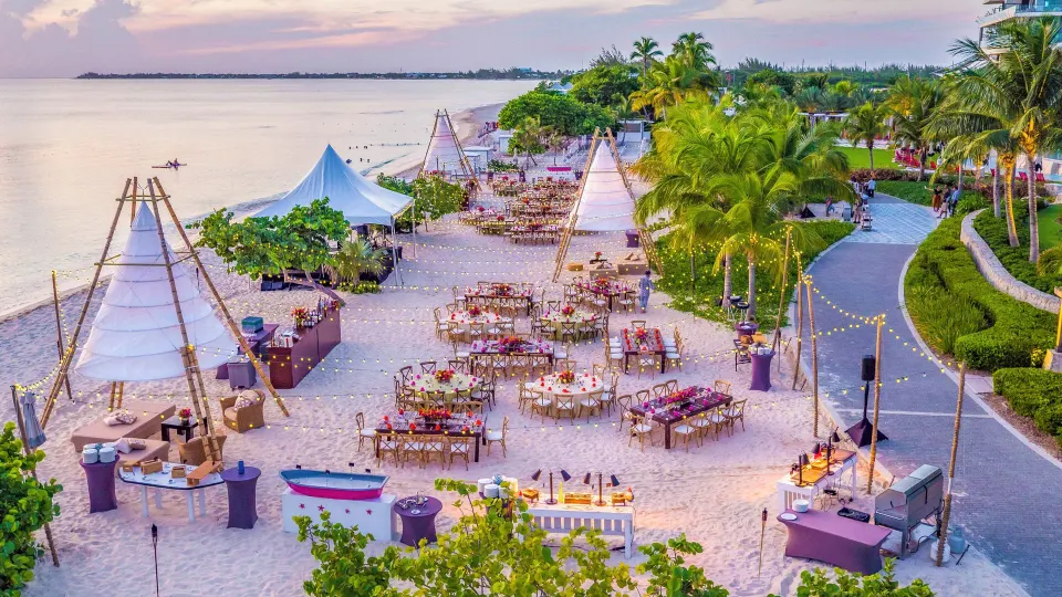 Sunset beachfront event setup on sand at Kimpton Seafire Resort + Spa