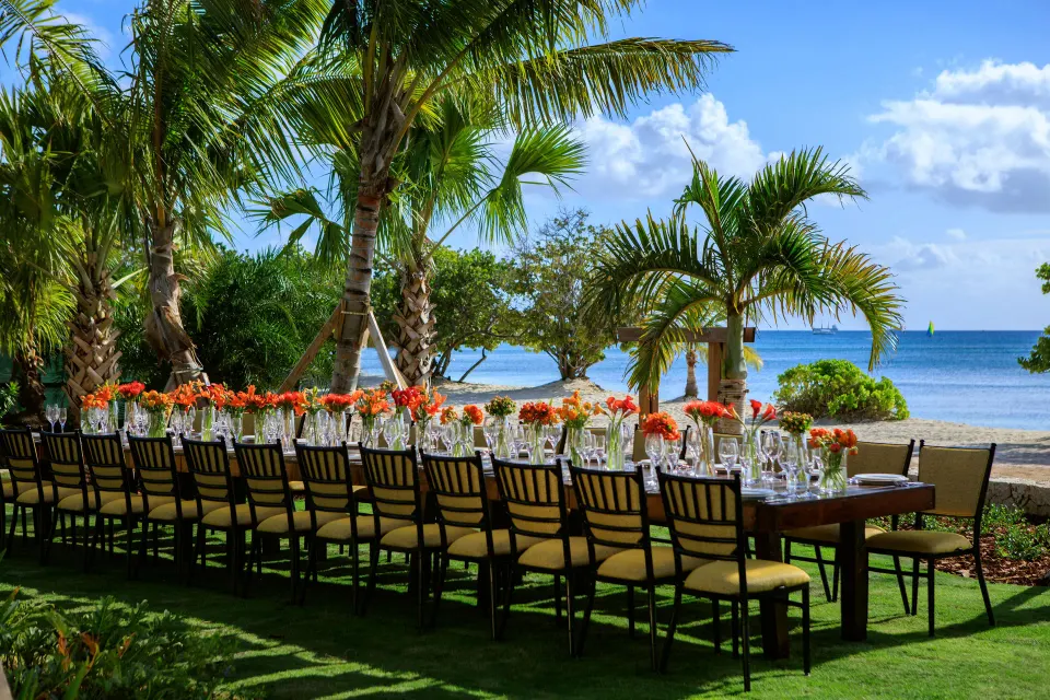 Long outdoor dining table by the sea at Kimpton Seafire Resort + Spa