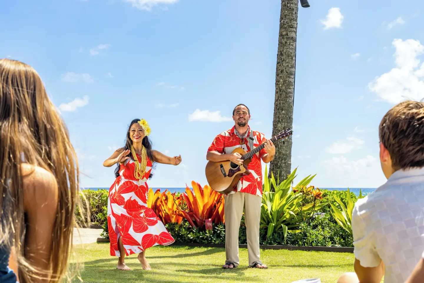 Hula dancer and guitarist perform on the lawn at Ko'a Kea Resort on Po'ipu Beach.