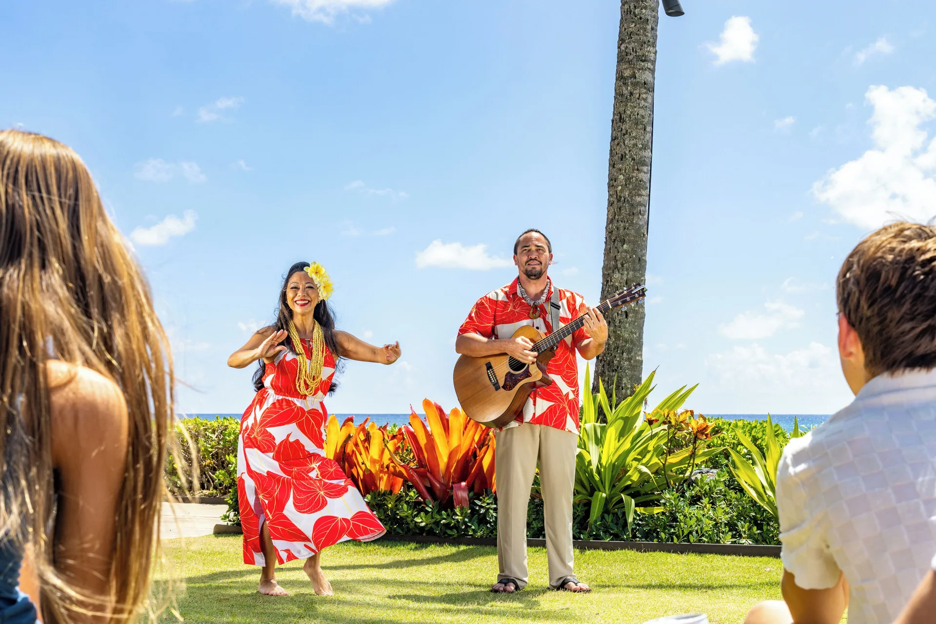 Hula dancer and guitarist perform on the lawn at Ko'a Kea Resort on Po'ipu Beach.