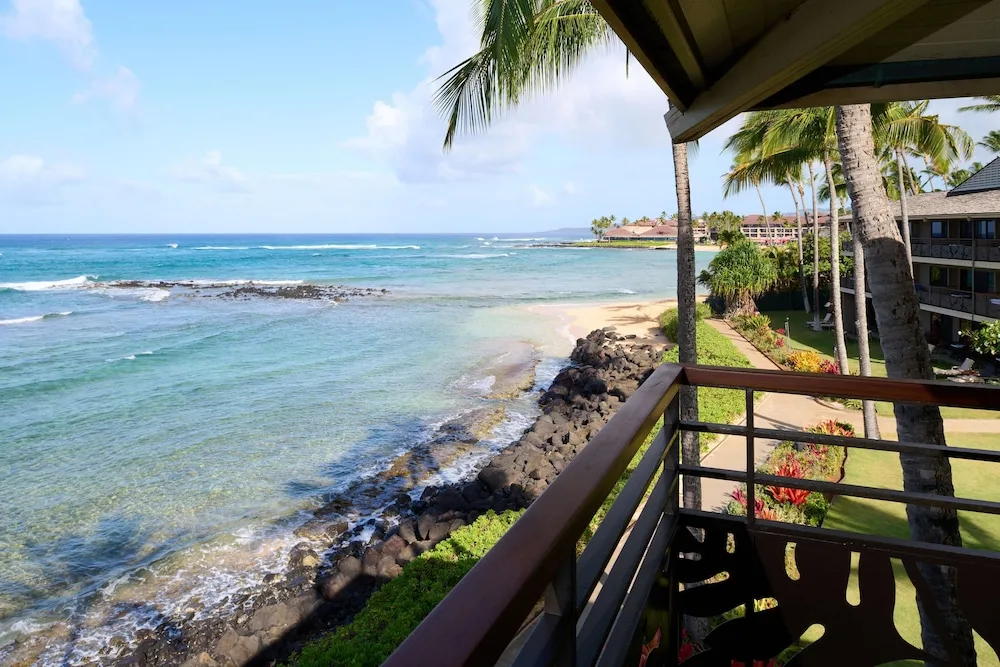 Balcony view of the rocky shoreline and blue ocean at Ko'a Kea Resort on Po'ipu Beach.
