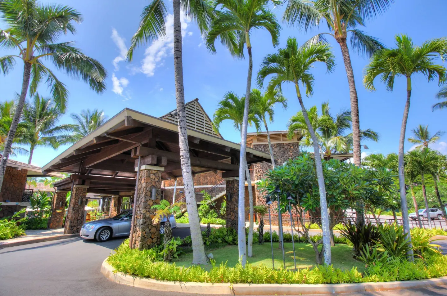 Palm-lined porte cochere entrance at Ko'a Kea Resort on Po'ipu Beach.